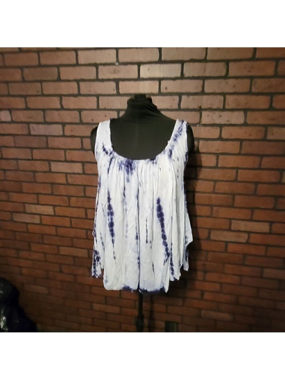 En Creme tie dye tank top with lace up detail in the back.